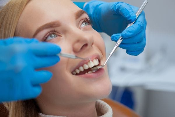 Dental hygiene woman sat in chair having dental hygiene appointment
