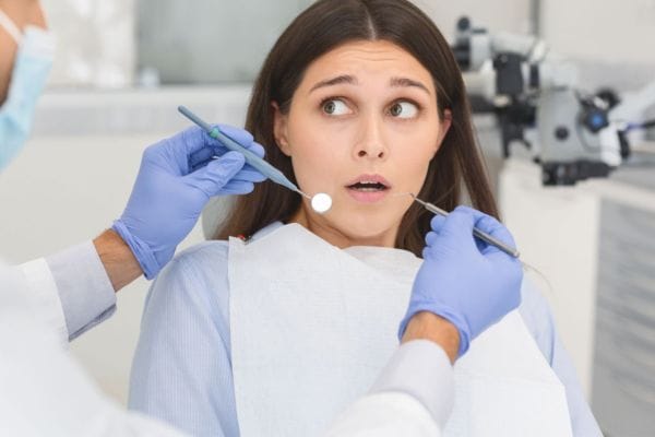 woman anxious about the dentist sat in dental chair