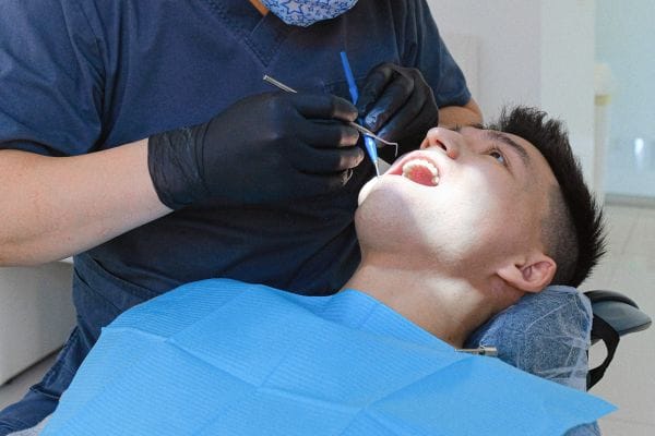 Man in dental chair during one of his routine dental examinations 