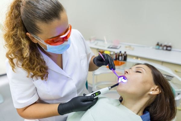 woman suffering dental anxiety having dental treatment with Conscious Sedation