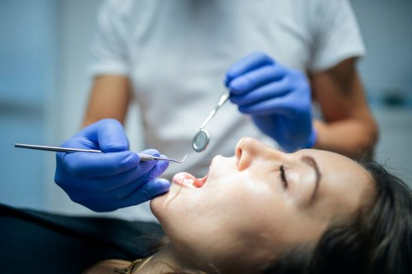 close up of a woman in dental chair during a complex dental examination