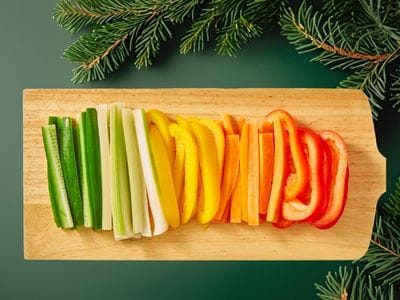 Crunchy vegetables wooden board with a selection of carrots, peppers and celery